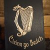 Irish Harp engraved on slate Black slate plaque featuring a gold-etched Irish harp with the words "Éirinn go Brách" in Gaelic script below.